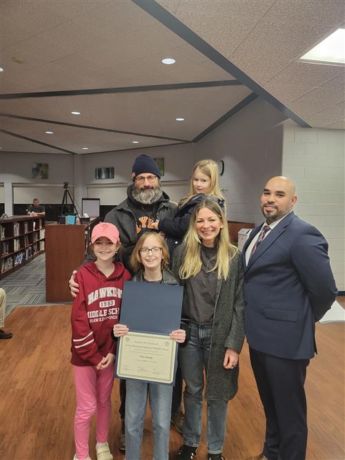 Photo of January 2023 student of the month for the Great Meadows Middle School Willow Butkosky with family and principal
